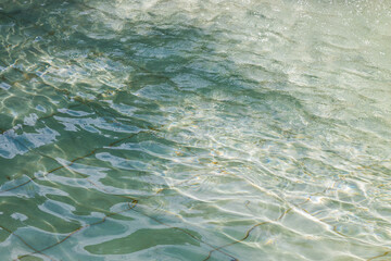 The texture of the spreading water in the fountain, swaying in the sunlight