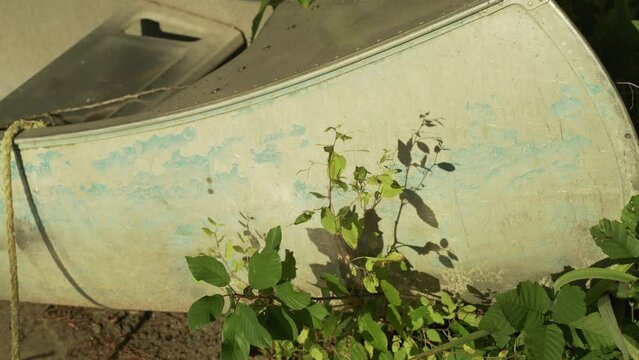 Aluminum Canoe on shore. High quality 4k footage with water reflecting on the side 