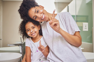 Face, mother and child with skincare cream at home or spa for facial cleaning, cosmetics and dermatology treatment. Smile, beauty and happy mom with her baby girl doing morning routine with lotion