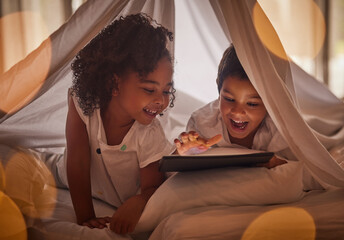 Children, tablet and night streaming online for movies, cartoon or educational games before bedtime in a blanket fort with a fun app. Excited boy and girl kid sharing, reading and internet addiction - Powered by Adobe