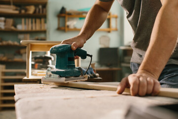 Grinding machine makes wooden polishing of bar plank.