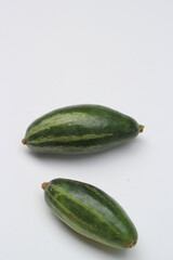 Fresh pointed gourd on a white background, green healthy vegetable