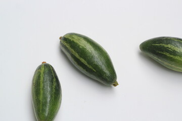 Fresh pointed gourd on a white background, green healthy vegetable