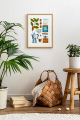 Sunny and cozy interior of living room with wooden stool, mock up poster frame , plants, rattan basket decoration, book and personal accessories. Stylish home decor. Template.