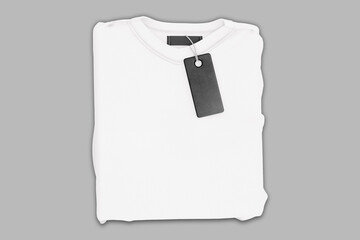 Fototapeta Empty blank white folded t-shirt with black tag label mockup isolated on white background.3d rendering. obraz