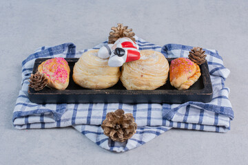 Christmas cookies on dark plate with Santa toy