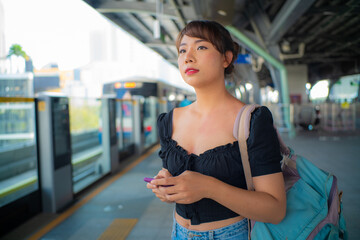 Fototapeta premium Beautiful asian woman use smartphone travel in city train
