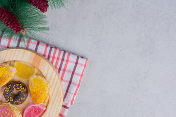 Christmas cookies, donut and marmalades on dark plate