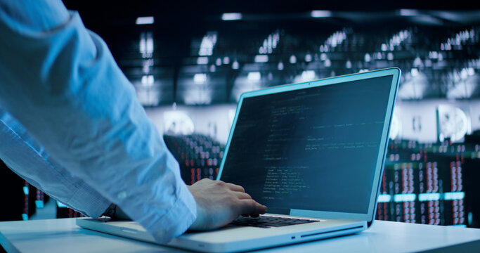 Caucasian Man, IT Technician Using Laptop, Doing Maintenance and Diagnostics in the Server Room. Cloud Storage Technology, Database, Engineering