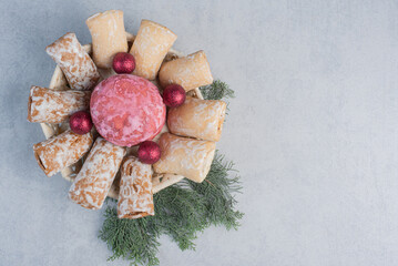 Cookies bundled in a white basket on a pile of pine branches