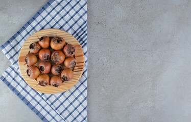 A wooden board with fresh juicy persimmons