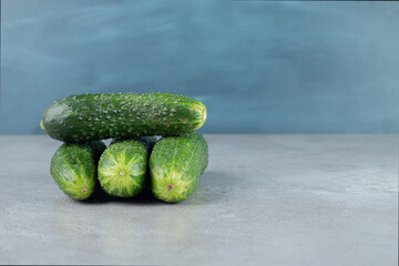 Four fresh cucumbers isolated on a gray background