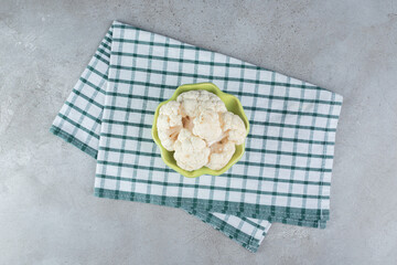 Uncooked fresh cauliflower vegetable on a tablecloth