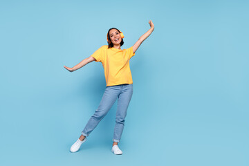 Obraz premium Full length photo of young cute korean woman celebrate dancer empty space headphones advert disco hands up positive vacation isolated on blue color background