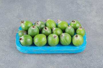 Fresh feijoa fruits on blue plate