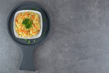 Rice with carrot slices and broccoli on white plate