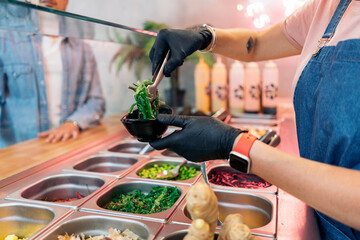 Woman Adding Ingredients Into Poke Bowl