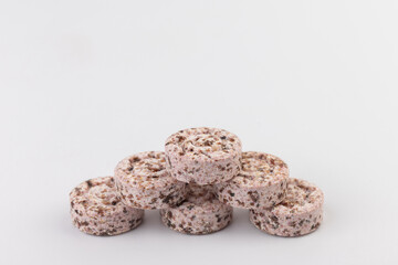 Heap of medicine colored pills, tablets on a white background