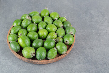 Fresh feijoa fruits on wooden plate