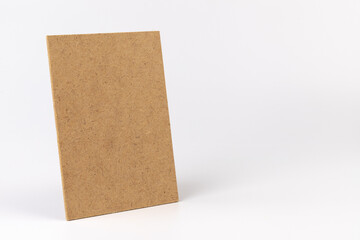 Brown cardboard sheet of paper on white background. Space for your disigne.