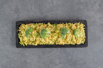 Delicious rice with broccoli on black plate