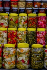 Vertical shot of a farmer's market in Bursa Turkey selling homemade pickles, olive oil and herbs