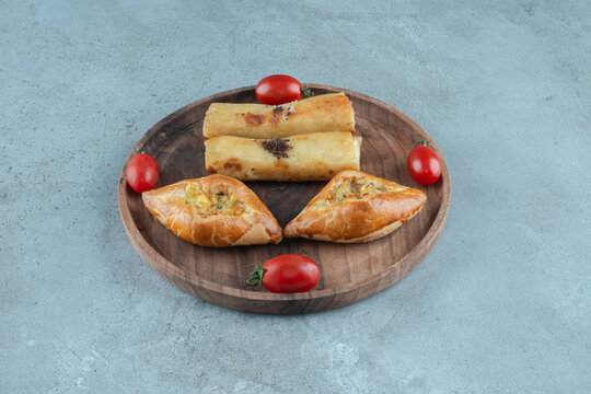 Turkish pide and russian blins on a small tray on marble background