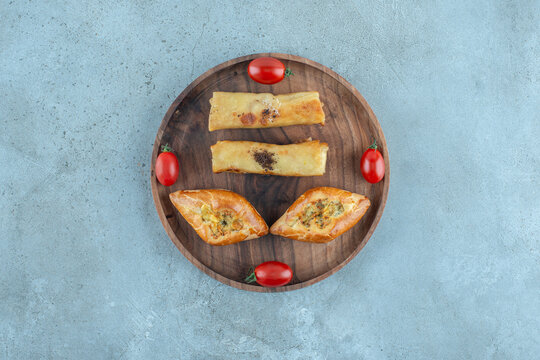 Turkish pide and russian blins on a small tray on marble background