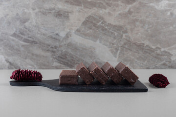 Chocolate coated wafers on a black board on white background