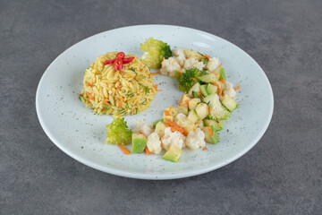 Tasty rice and healthy vegetables on white plate