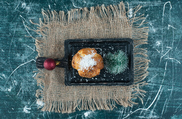 Delicious muffin with Christmas small tree and ball