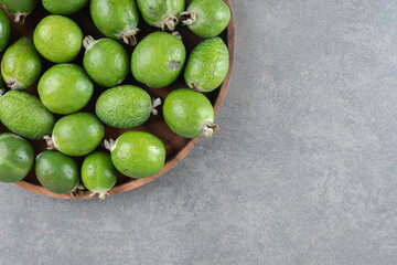 Fresh feijoa fruits on wooden plate