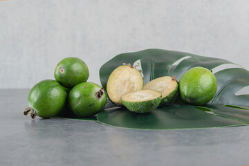 Delicious feijoa fruits on green leaves