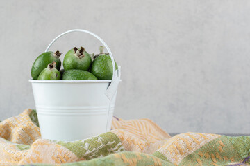 Delicious feijoa fruits in white bucket