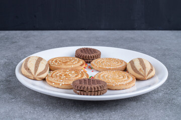 Various sweet biscuits on white plate