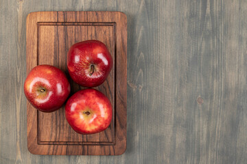 Juicy apples on a wooden cutting board
