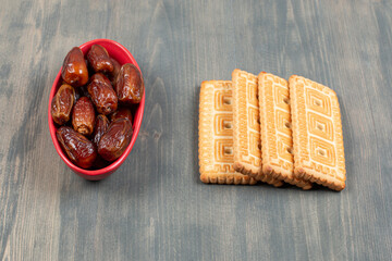 Delicious cookies with dried dates on a wooden table