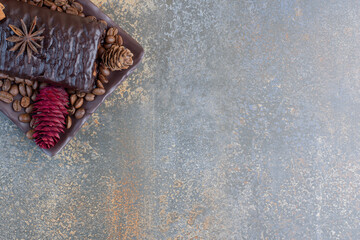 Chocolate roll with coffee beans and pinecones