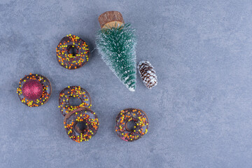 Chocolate donuts with Christmas ball and Christmas small tree