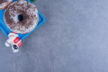 A blue board of sweet chocolate cookies with Christmas toy