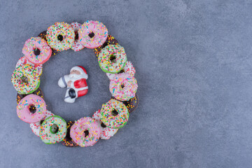Colorful sweet fresh donuts on a gray background