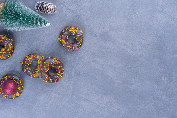 Delicious donuts with Christmas tree and pinecones