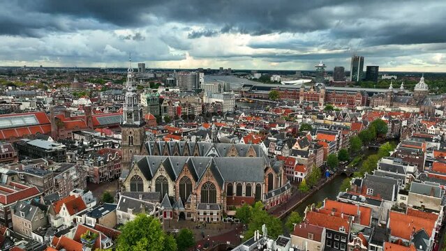 Aerial view of famous places Amsterdam, Netherlands. View of canal and old centre district. span around the church de oude kerk