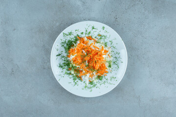 Chopped cabbage and carrots on white plate