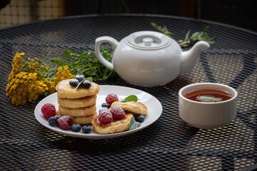 cup of tea with cheesecakes on a balcony table