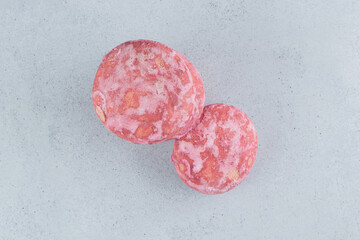 Pink cookies bundled together on marble background