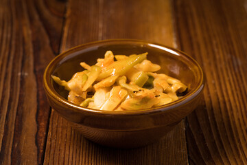 Shredded mustard on wooden background