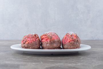 Small snack cakes on a platter on marble background