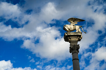 Padua, Italy. Monument in city centre. Column with a statue of a winged lion at the top. San Marco Column in front of the Palazzo della Loggia on Piazza dei Signori.