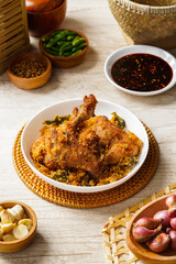 Ayam Goreng Padang. Traditional fried chicken with spice crumbs from Minangkabau, West Sumatra. served on white plate 